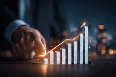 An image displays a digital financial graph with an upward trend, highlighted by a glowing line. A human hand subtly interacts with the visual data. The composition features a dark, professional ambiance, potentially suited for illustrating financial reports and business-related topics. It can be used in commercial and editorial contexts.の素材