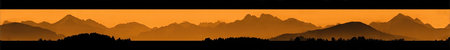 An abstract landscape portrays mountain silhouettes under a vibrant orange and yellow sky during sunset. The image displays a gradient of warm colors, with a dark foreground creating contrast. This scene might be suitable for various commercial uses, including website backgrounds and print media.の素材