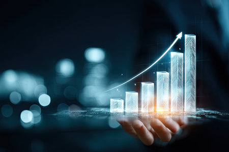 A person's hand supports a glowing bar graph with a rising arrow, set against an out-of-focus background. The image showcases digital art with cool tones and highlights. The concept suggests progress and growth for potential uses in business or finance contexts.の素材