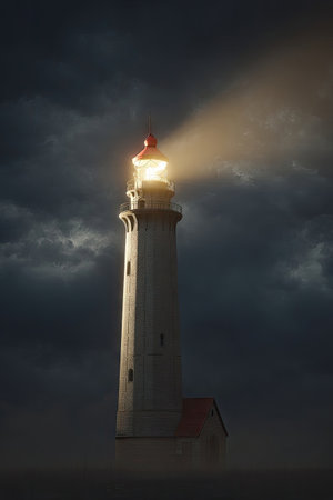A tall lighthouse stands prominently against a dramatic, overcast sky. Its white structure contrasts with the dark clouds, while a bright beam of light emanates from its lamp. The scene evokes a sense of guidance, hope, and safety in a potentially challenging environment, suitable for various editorial and commercial applications.の素材