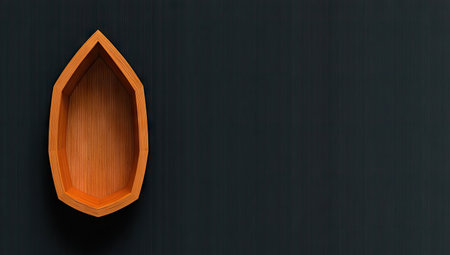 A wooden boat-shaped container is presented against a dark backdrop. The object has a warm, orange hue and a geometric design. The composition features a top-down view, with ample copy space on the right, and could be utilized for various commercial and editorial projects. The lighting is diffused and even.の素材