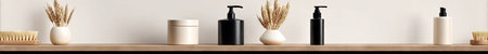 This image showcases a minimalist bathroom setup with neutral tones and natural materials. Several beauty products and decorative elements are arranged on a wooden shelf against a white backdrop. The composition suggests a serene and clean aesthetic, suitable for various commercial applications.の素材