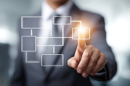 A business professional in a suit is interacting with a digital flow chart displayed in front of them. The image features a composition with bright lighting and a shallow depth of field. This visual could be utilized for presentations, articles, or marketing materials within the business and technology sectors.の素材