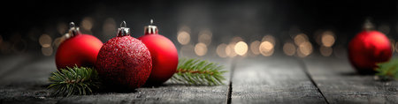 This image showcases vibrant red Christmas ornaments paired with green pine branches, set against a dark, blurred background. The composition highlights the textures of the ornaments and wood. The overall aesthetic is warm and inviting, suitable for a range of uses related to the festive season.の素材