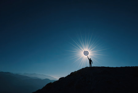 A dark silhouette of a person on a hill reaches for a target against a bright sun. The image features a strong backlighting creating high contrast. The composition is simple, with emphasis on the shape and symbol. The picture suggests concepts such as achievement, goals, and success, suitable for various editorial and commercial applications.の素材