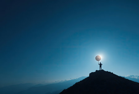 A silhouette of a person stands atop a mountain, holding a target against a bright sky. The image features a dark, crisp silhouette, contrasting with a gradient blue backdrop. This conceptual illustration could be utilized for various commercial purposes, like business or goal-setting projects.の素材