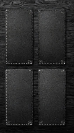 Four rectangular black leather pieces are arranged on a dark wooden surface. Each piece has white stitching around the edges. The composition presents a top-down view, with neutral lighting and a simple, clean arrangement suitable for various design and advertising projects.の素材