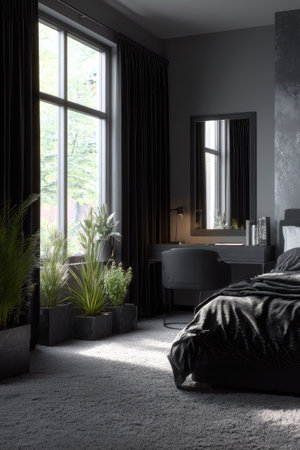 An interior space features a bed, desk, and large window. The scene is dominated by gray tones and dark curtains. Plants add a natural element, illuminated by sunlight. This image could be suitable for lifestyle blogs, interior design websites, or advertising materials.の素材