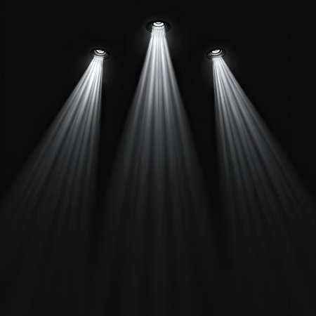 Three bright spotlights shine downwards from above in this image. The lights are white and focused, creating strong beams against a black background. The composition is simple, with vertical lines of light. The image could be used for various purposes, including graphic design or visual effects.の素材