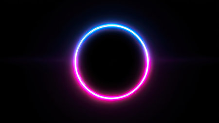 A luminous, neon circle is centered against a dark backdrop, emanating a vibrant glow of blue and pink. The circular form suggests a modern, digital aesthetic, highlighted by its intense luminosity. Ideal for various commercial applications, the image offers visual interest and copy space.の素材
