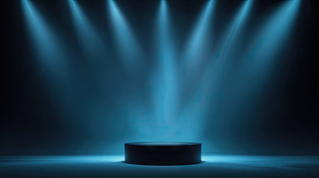 A dark circular podium stands center stage, bathed in blue light from multiple overhead spotlights. The composition features a shallow depth of field, emphasizing the pedestal against a gradient background. The style suggests a modern, minimalistic design. Suitable for product presentations or promotional material.の素材
