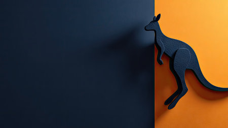 A dark silhouette of a kangaroo is positioned against a vibrant backdrop divided into orange and blue sections. The artwork presents a minimalist and graphic style with clean lines and a modern aesthetic. Ideal for illustrations or designs, this image can be used in various commercial applications.の素材