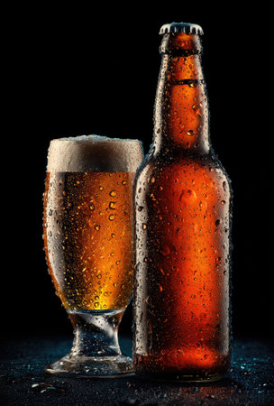 A close-up showcases a full pint glass and a sealed bottle, both containing amber liquid and covered in condensation. The image presents a high-contrast style with focused lighting and a dark background. It is suitable for promotional materials, food and beverage articles, and various other editorial needs.の素材