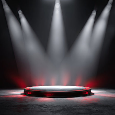 A dark scene showcases a circular platform bathed in bright spotlight beams. The stage features a glowing red outline, with a contrasting light source illuminating the surface. This composition uses a dramatic lighting scheme, which can be ideal for presentations, product showcases, or visual communication purposes.の素材