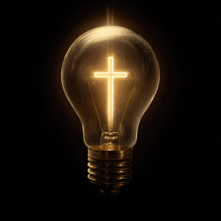 A lightbulb glows brightly, with a cross shape radiating light within. The image showcases a symbolic representation against a stark, black backdrop. The lighting highlights the textures and form. Suitable for illustrating ideas related to faith, inspiration, or innovative concepts.の素材