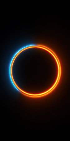An illuminated circular shape is centered against a dark backdrop. The composition features a vibrant, glowing ring that seems to emit radiant light. The color palette incorporates contrasting hues of blue and orange. This design is suitable for diverse commercial uses such as advertising or web design.の素材