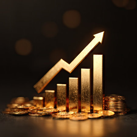 A golden bar graph with an upward pointing arrow sits atop a pile of coins against a dark background. The scene features warm lighting, highlighting the textures and metallic surfaces. It could be suitable for illustrating financial reports, economic trends, or business concepts.の素材
