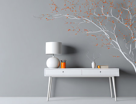 An interior shot showcases a white desk with a spherical lamp, set against a gray wall, and complemented by a decorative branch. The scene exhibits a minimalist aesthetic, featuring clean lines and neutral colors. This image could serve various purposes from lifestyle blog posts to commercial projects.の素材