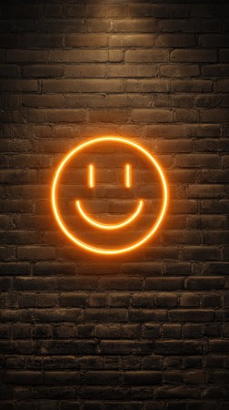 A glowing neon smiley face illuminates a textured brick wall in this vertical composition. The image features warm orange tones against a dark brown backdrop. This digital illustration evokes feelings of positivity and could be suitable for various design projects, web graphics, and editorial uses.の素材