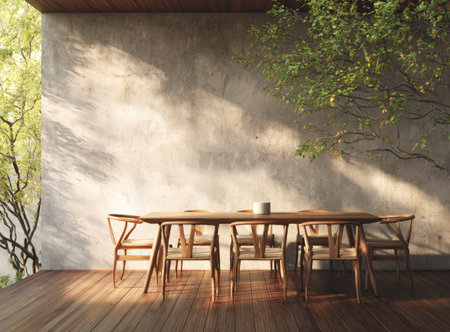 A wooden table and chairs are arranged on a terrace, bathed in natural sunlight. The scene includes a textured wall and tree branches, with light and shadow creating a striking visual composition. This image is suitable for various commercial purposes, including design and lifestyle concepts.の素材