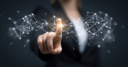 A woman's hand points toward a digital network of interconnected lines and dots. The image features a shallow depth of field, with the focus on the hand and the network. The color palette is cool with hints of bright light. This image could be used for various commercial projects related to technology.の素材