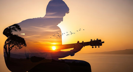 A silhouette of a person playing a guitar merges with a vibrant sunset, creating a dreamy and atmospheric composition. The image showcases warm orange and yellow hues, with a textured sky and landscape. Suitable for various creative projects and visual storytelling, the scene evokes a sense of peace and artistic expression.の素材