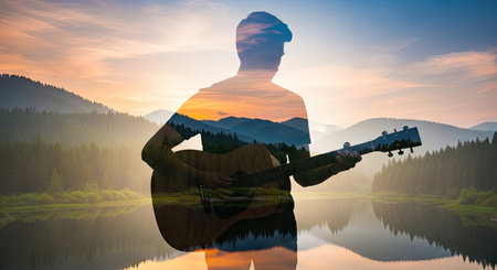 A silhouette of a person playing a guitar is overlaid on a serene landscape. The image features a vibrant sunset casting warm colors across the sky, with gentle reflections on the water. The composition suggests a connection between music and nature. Suitable for various creative and illustrative applications.の素材