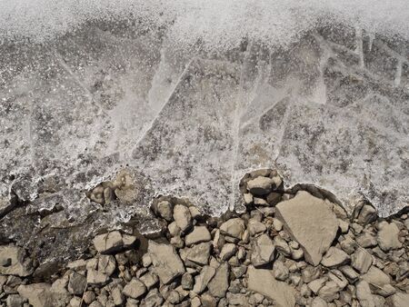 Ground texture. Ice layer over stones.の写真素材