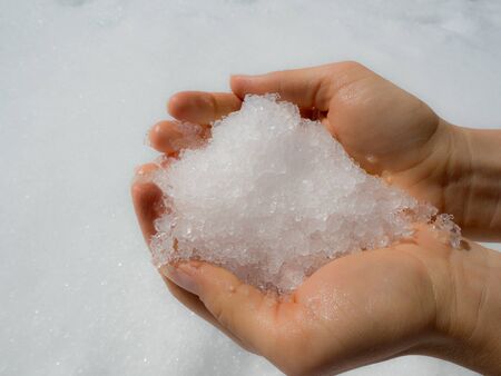 Winter feeling. Holding snow in your hands.の写真素材