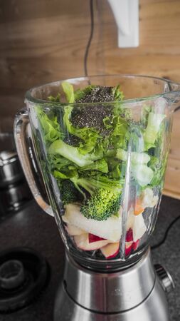 Blender with healthy ingredients for a delicious green smoothie.の写真素材