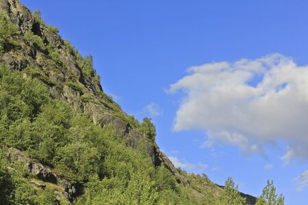 Clouds are flying above mountains in beautiful Hemsedal, Buskerud, Norway.の写真素材