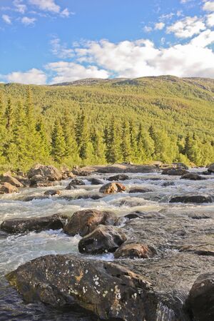 River of the beautiful waterfall Rjukandefossen with mountain views to the sunset in Hemsedal, Buskerud, Norway.の写真素材