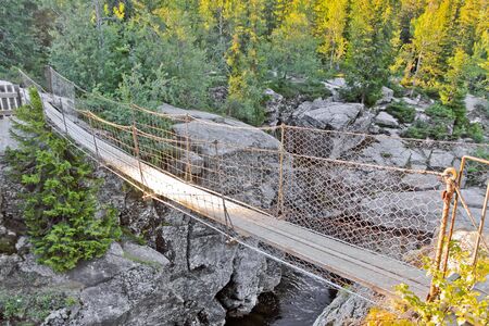 Beautiful suspension bridge over the Rjukandefossen waterfall in Hemsedal, Norway.の写真素材