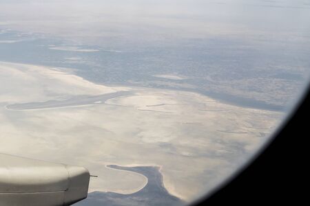 View from an airplane window at high altitude and turbines about Africa.の写真素材