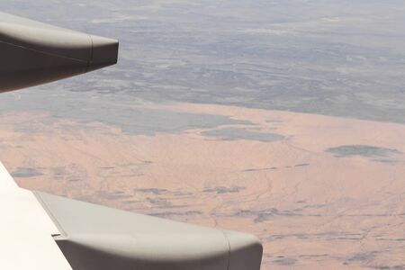 View from an airplane window at high altitude and turbines about Africa.の写真素材