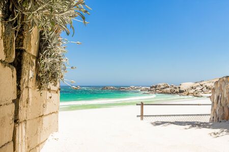 Camps Bay Beach behind fence and wall in Cape Town.の写真素材