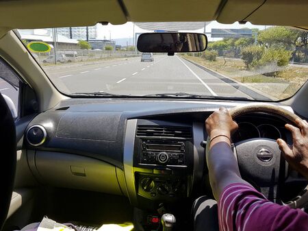 Taxi driver in Cape Town, South Africa. In the car, taxi, while driving in the back seat.の写真素材