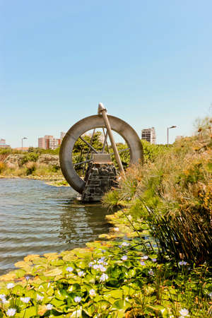 Watermill, mill with water, in the lake or pond in Green Point Park Cape Town, South Africa.の写真素材