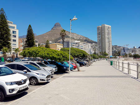 Mountains, hotels and parking cars at the Sea Point, beach promenade in Cape Town South Africa.