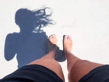 Woman barefoot on sand in Camps Bay, Cape Town.の写真素材