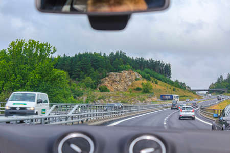 Driving through the Norway countryside in a car. Sitting in the car.のeditorial素材