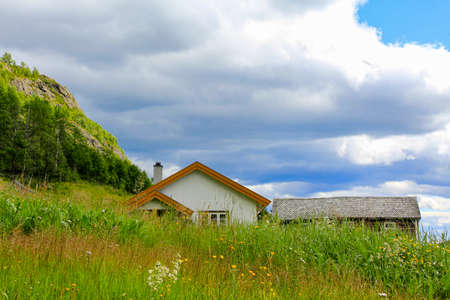 White cottage on a mountain in a meadow in Hemsedal, Viken, Buskerud, Norway.の写真素材