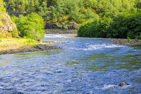 Flowing beautiful blue river lake Hemsila with mountain panorama in Hemsedal, Viken, Buskerud,...