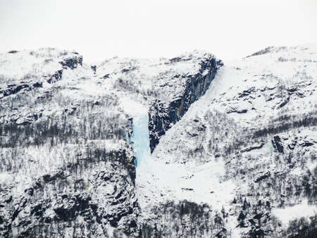 Frozen waterfall and icicles in a beautiful landscape in Norway.の写真素材