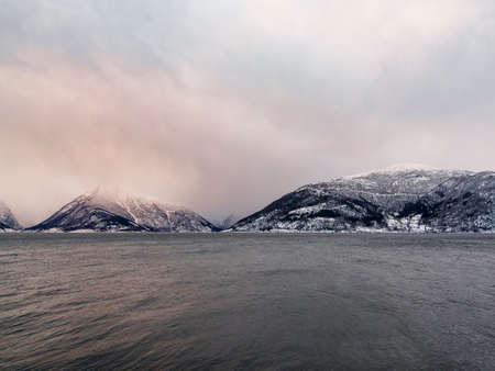 Ferry from Vangsnes to Dragsvik, Balestrand. Winter landscape and fjord with sunrise sunset in...