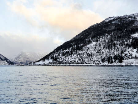Ferry from Vangsnes to Dragsvik, Balestrand. Winter landscape and fjord with sunrise sunset in...