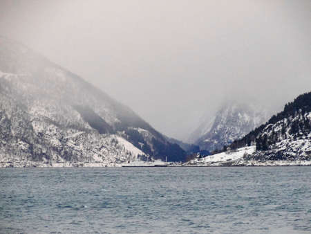 Ferry from Vangsnes to Dragsvik, Balestrand. Winter landscape and fjord with sunrise sunset in...
