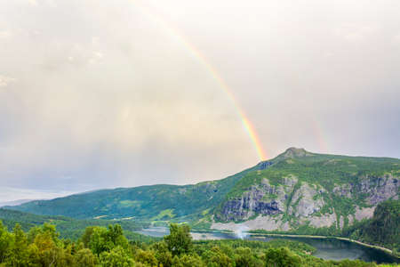 Colorful rainbow over the lake VangsmjÃ¸se and mountain panorama in Vang i Valdres, Innlandet, Norway.の写真素材