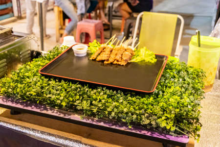 Chicken skewers Thai night market street food in Huai Khwang, Bangkok, Thailand.の写真素材