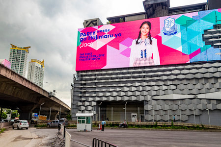 Huge colorful screens at the shopping center building in the metropolis of Bangkok in Thailand. Huai...